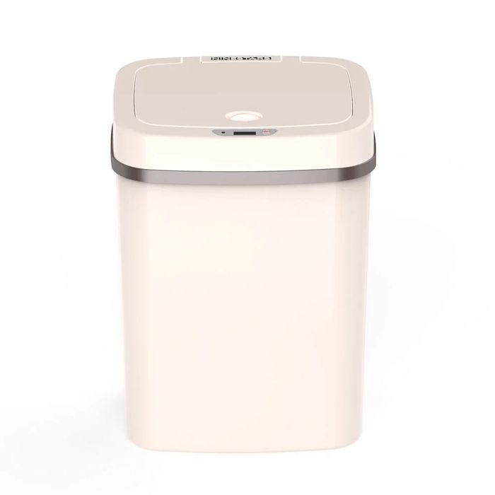 A cream-colored, no-touch bathroom waste basket.
