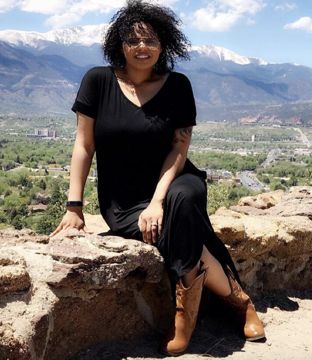 A reviewer wearing the black dress.