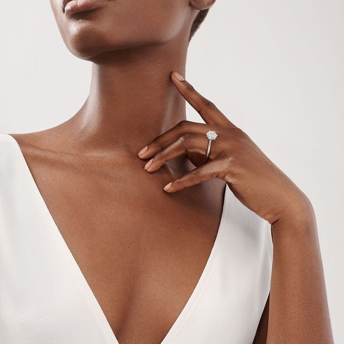 A model showcasing a brilliant-cut solitaire diamond ring
