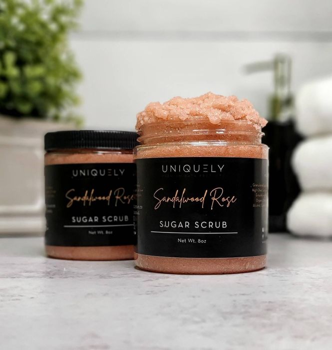 A body scrub rests on a marble table.
