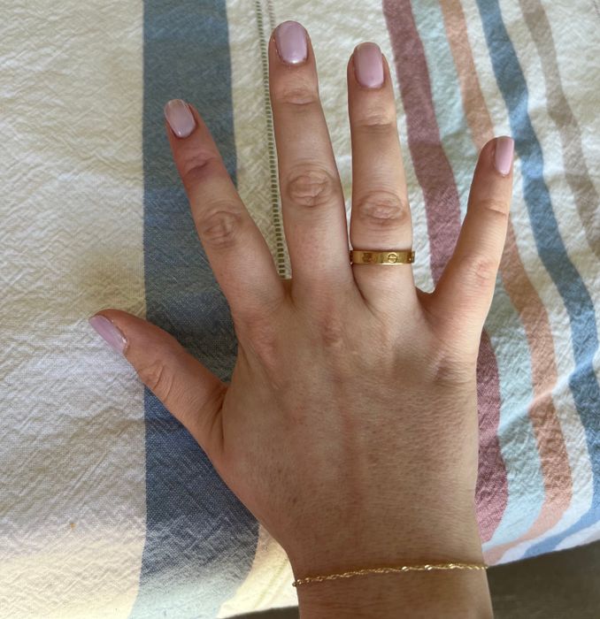 Mytour editor wearing a gold Cartier love band ring
