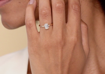 A model showing off the elegant emerald-cut pavé ring
