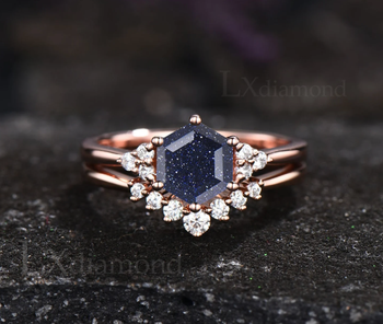 A hexagon-cut dark blue sandstone set in a rose gold band, accompanied by an additional diamond-studded band for a dazzling touch.