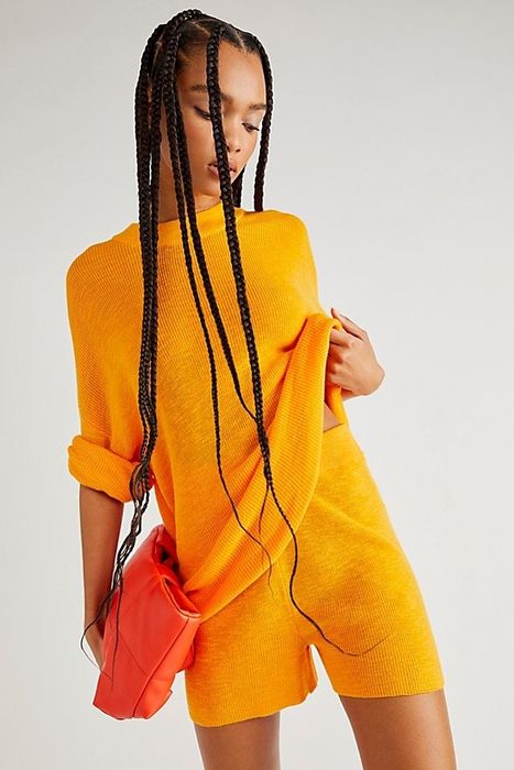 Model sporting a stylish orange set