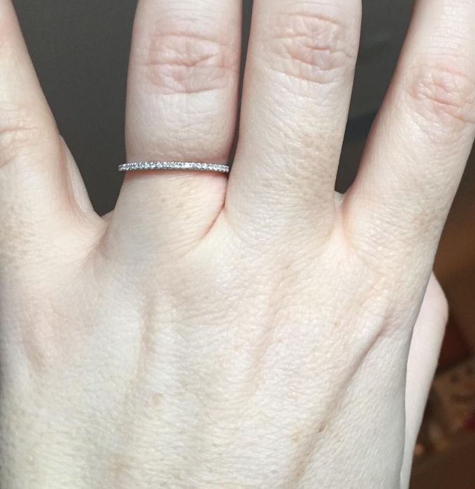 A reviewer wearing the elegant, thin diamond band