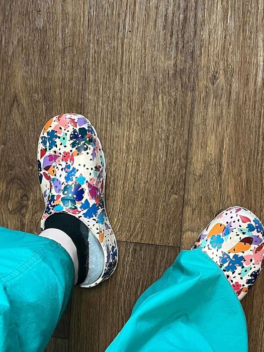 Another reviewer shows off their patterned clogs paired with turquoise scrubs.