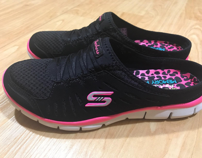 Reviewer displays a pair of black and pink sneakers.