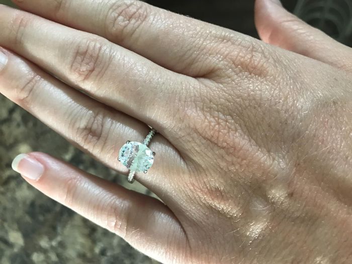 An Amazon reviewer flaunting the ring with a delicate stone band and an oval center stone