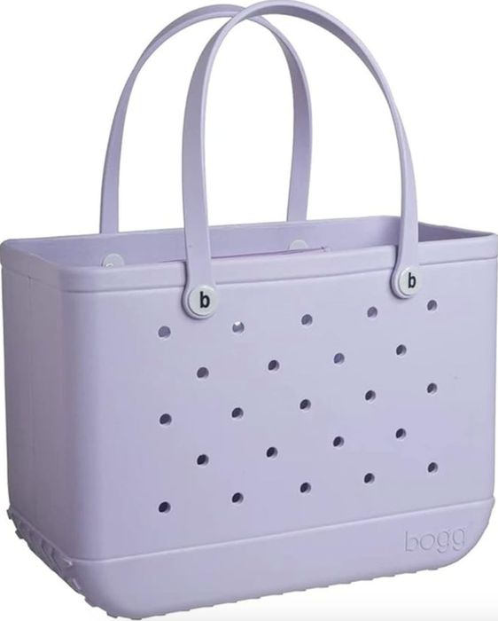 A Bogg Bag tote featuring a perforated design and two handles, displayed in this product image for a shopping article.