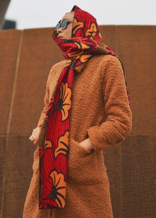 A model draped in a scarf over her head