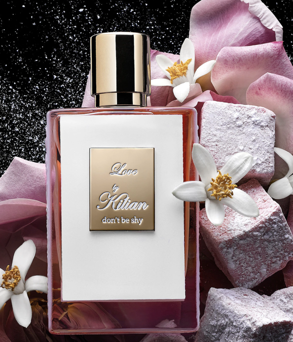 Perfume placed delicately on petals and rocks