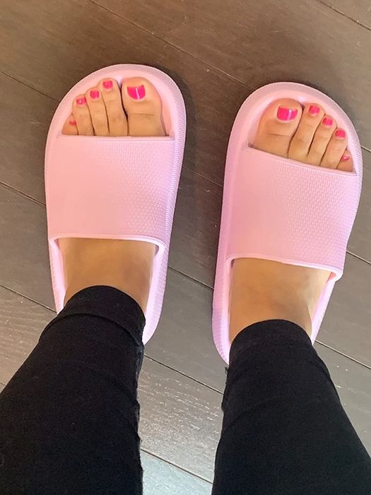 an additional reviewer modeling pink slide sandals