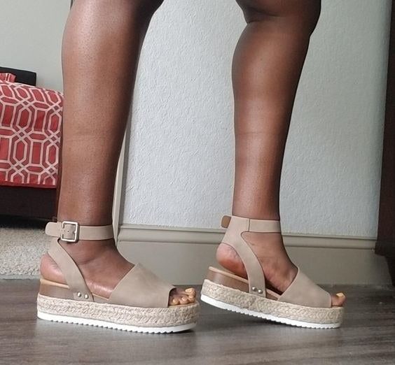 Reviewer modeling taupe-colored sandals