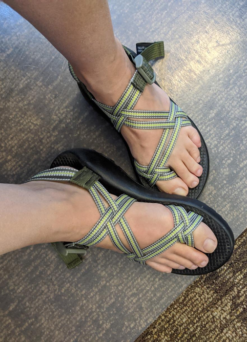 the reviewer showcasing a pair of green Chacos