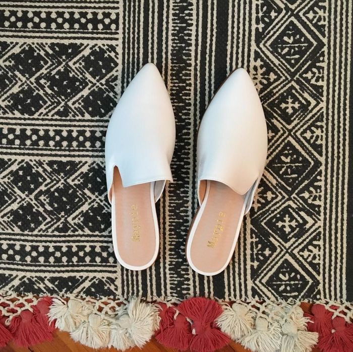 The elegant white backless flats