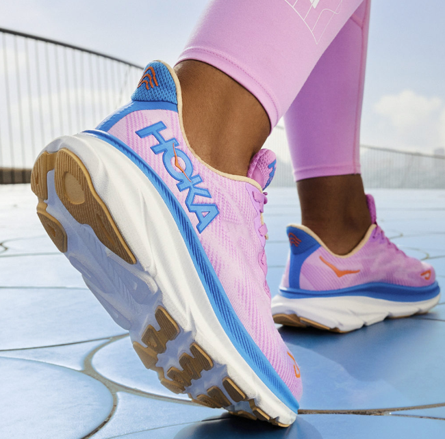 A model showcasing the pink and blue sneakers.