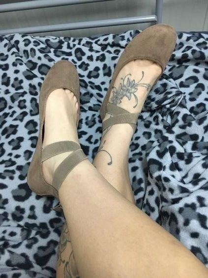 Reviewer showcasing taupe-colored flats