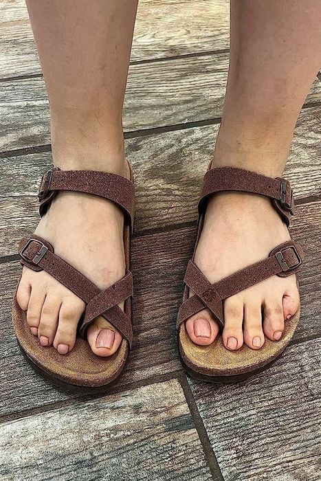 A reviewer's photo featuring brown sandals.
