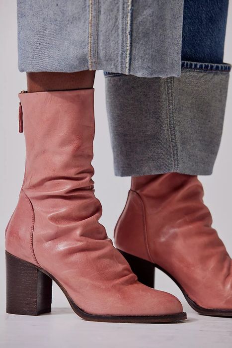 A close-up of another model styling the boots in a sunset sand color.