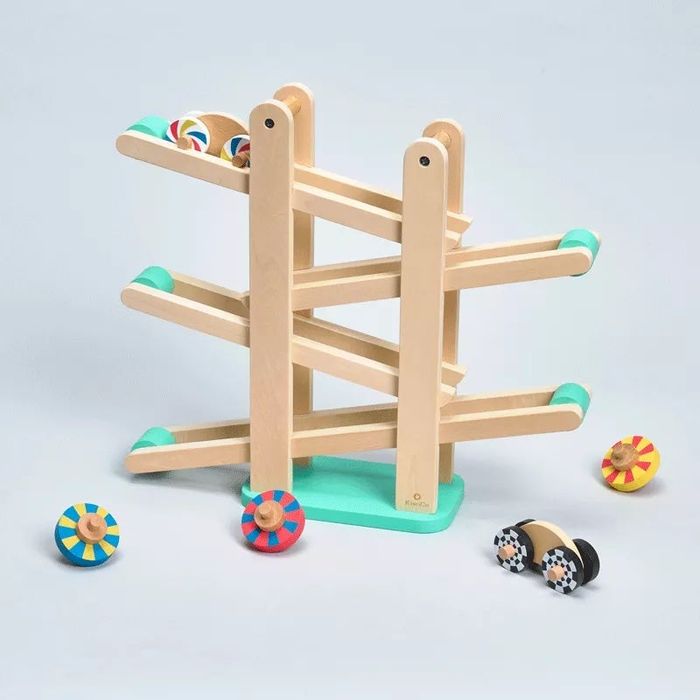 a wooden ramp toy with vibrant wheels and cars designed to roll down it