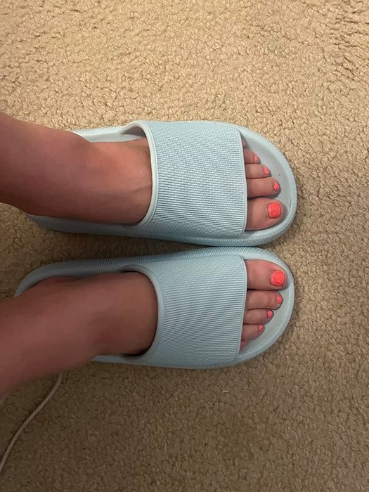 a reviewer showcasing blue footwear