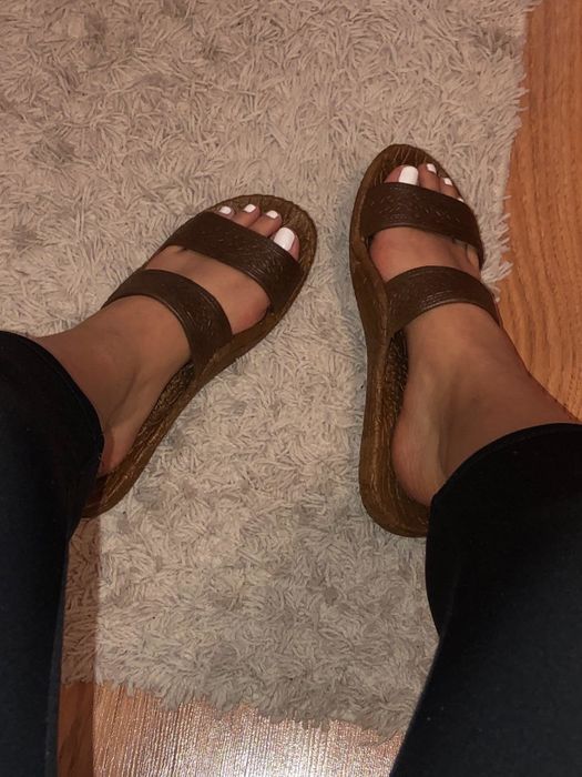 Reviewer wearing the brown slide sandals