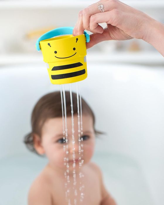 A yellow bee-themed bath bucket toy