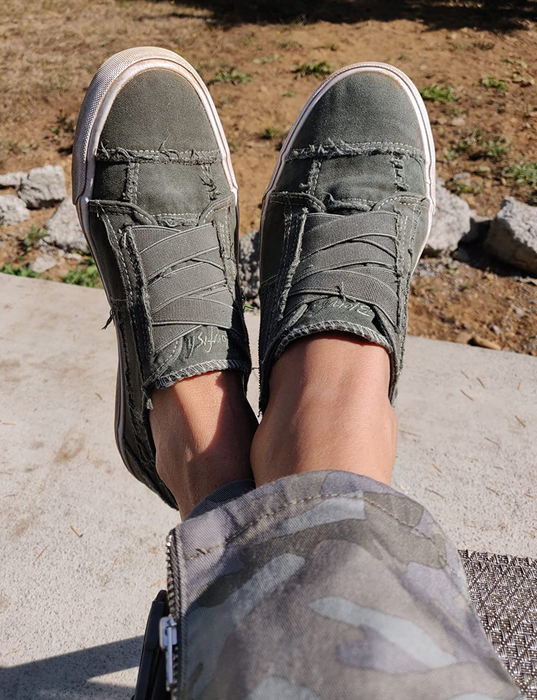 Reviewer wearing green slip-ons.