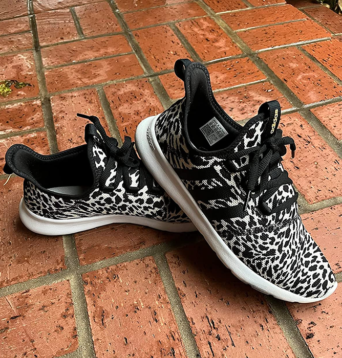 A close-up shot of a reviewer’s leopard print sneakers.