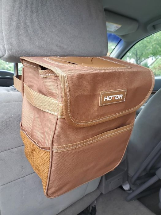 A car trash can hanging from a headrest, branded