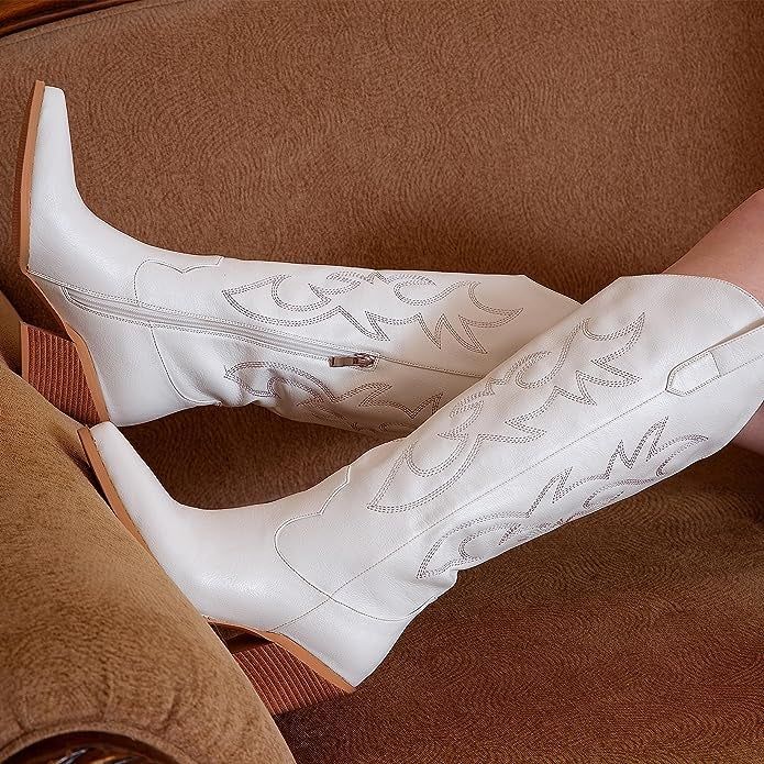 A model showcasing the stylish white Western boots.