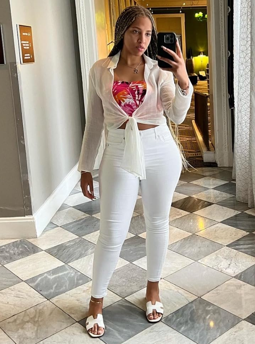 A reviewer wearing the sandals in white.