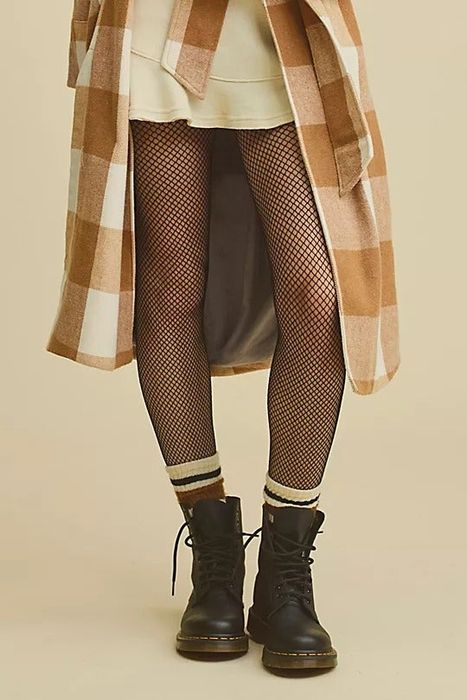 A model rocking black lace-up Dr. Martens boots.