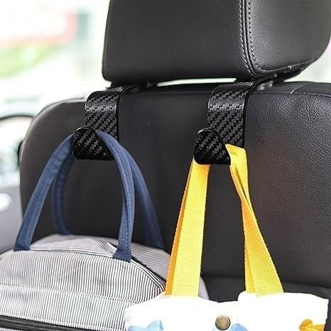 Car seat hooks are used to suspend shopping bags from the back of a car seat's headrest, providing a convenient storage solution.