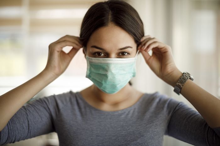 A person putting on a mask