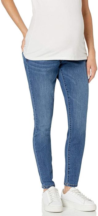 model wearing mid-wash maternity jeggings