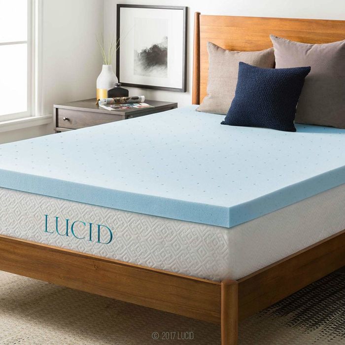 A blue mattress topper neatly placed on a bed, adding an extra layer of comfort.