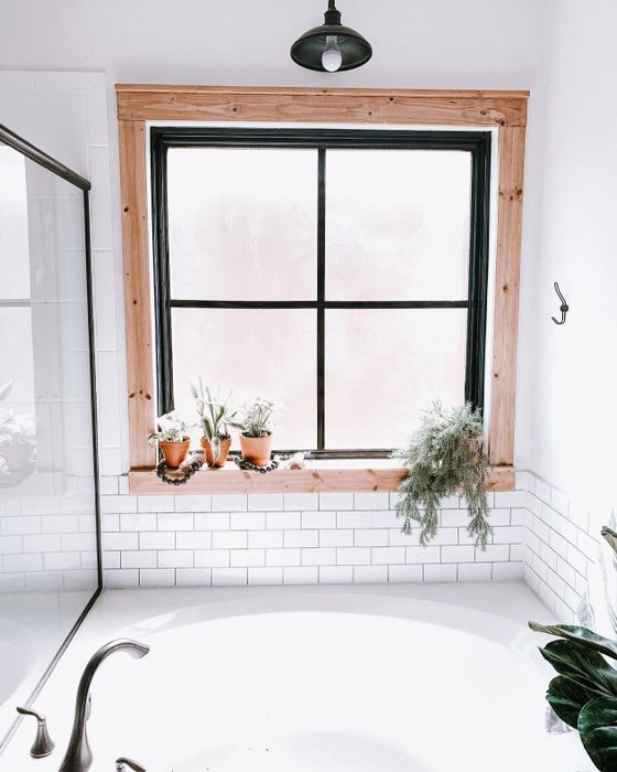 the same reviewer's bathroom now featuring the sleek white subway tiles