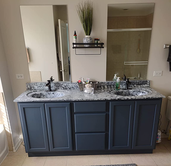 the same reviewer’s bathroom vanity now looking modern with granite peel-and-stick and a fresh paint color