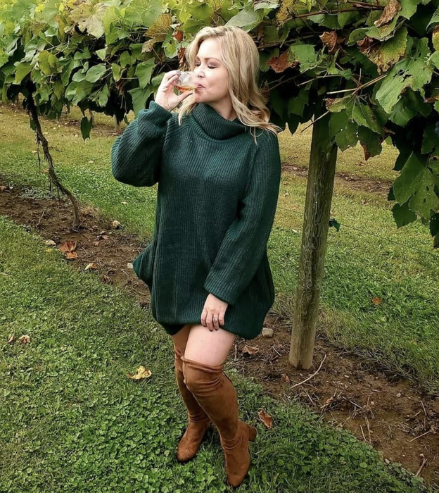 A reviewer rocking the sweater dress in a stunning green shade, perfect for fall events.
