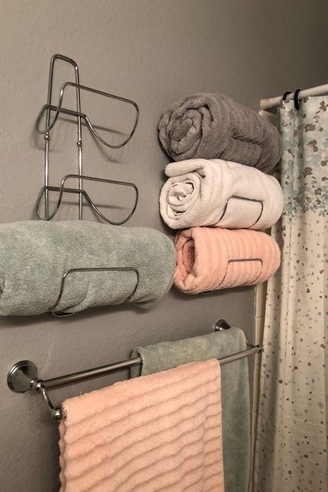 a reviewer’s photo of the towel racks installed on their bathroom wall