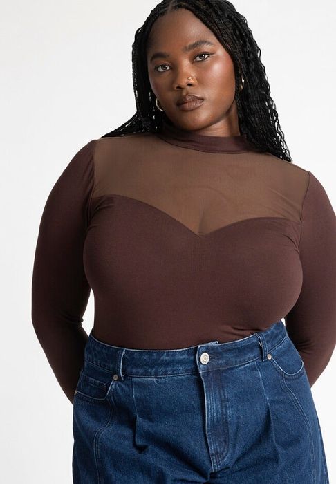 A model wearing the brown yoke mock neck mesh top