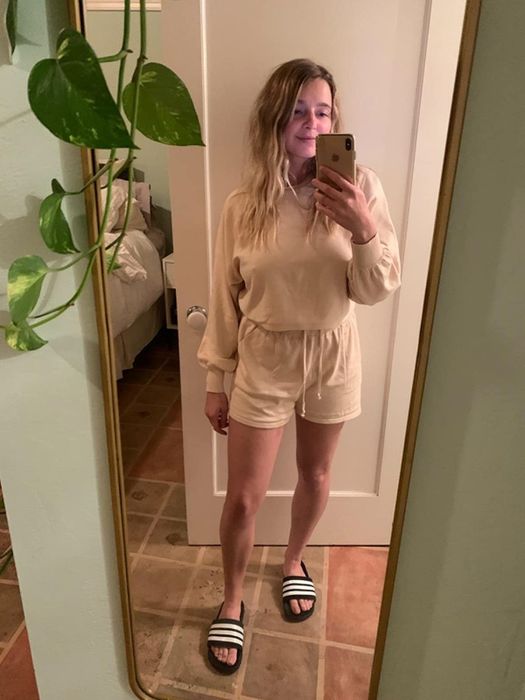 a reviewer in the tan long sleeve and shorts set