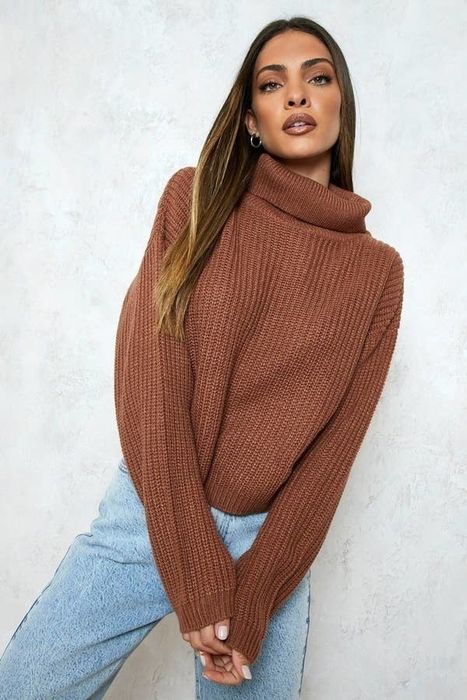 A model showcasing the cropped sweater with a high neckline