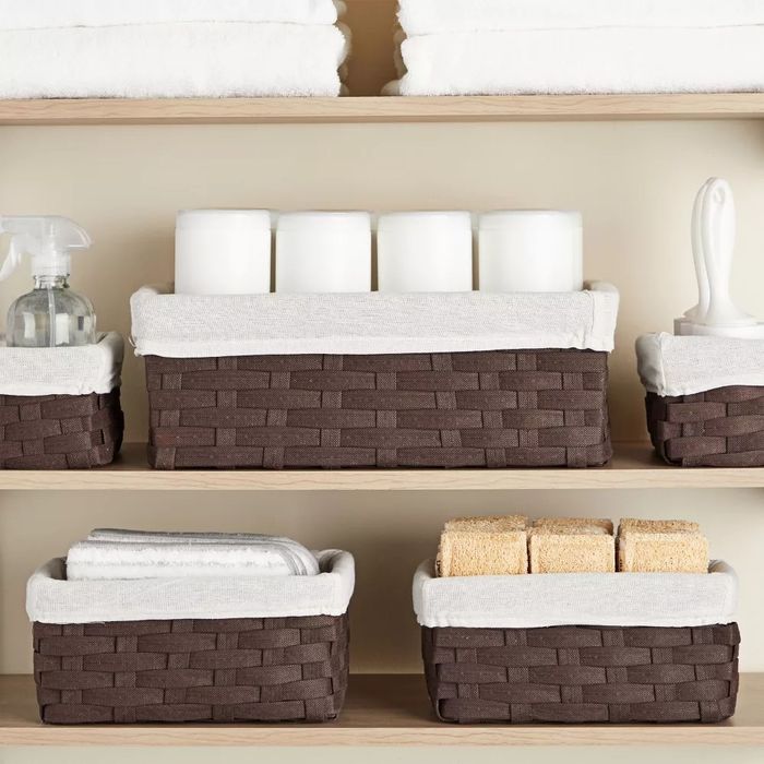 Nesting baskets filled with sponges, towels, and more.