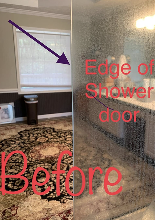 a glass shower door obscured by hard water stains, as observed by a reviewer