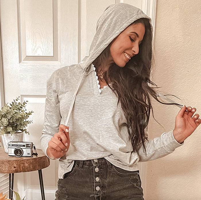 A reviewer flaunting the hoodie in a stylish and casual manner.