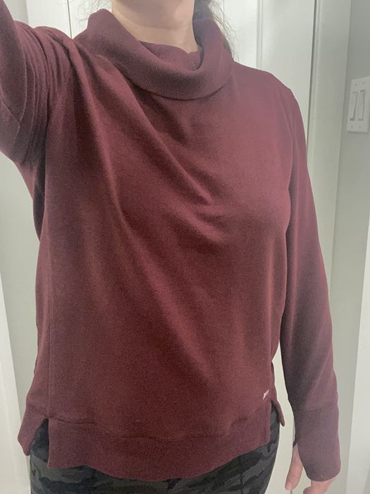 A reviewer sports a burgundy cowl neck sweatshirt.
