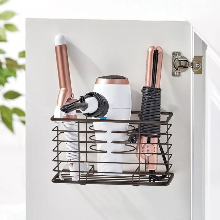 The dryer stand is mounted on the inside of a cabinet door.