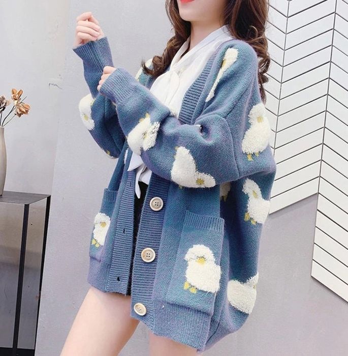 A model wearing the blue sheep cardigan with oversized buttons